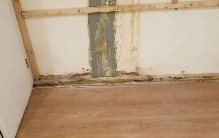 Wall opened at the base after a burst supply line soaked the framing